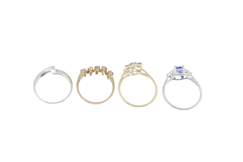 A selection of four 9ct gold gem-set dress rings. To include a coloured treated blue diamond - Image 4 of 4
