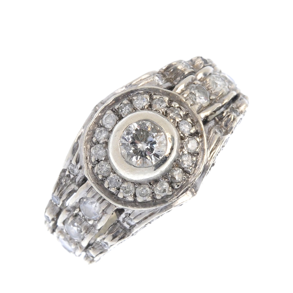 (15968) A 9ct gold diamond dress ring. Designed as a brilliant-cut diamond collet within a