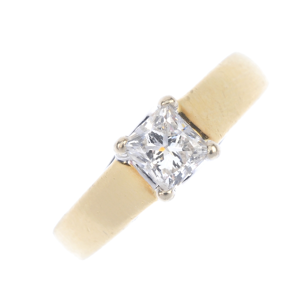 An 18ct gold diamond single-stone ring. The square-shape diamond, to the plain band. Diamond