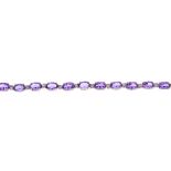 A 9ct gold amethyst and diamond bracelet. The oval-shape amethyst line, with diamond double spacers,