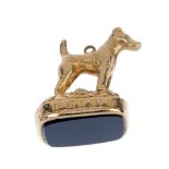 A mid 20th century 9ct gold dog fob. Depicting a terrier, with cushion-shape onyx seal terminal.