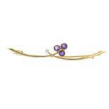 An early 20th century 15ct gold amethyst and seed pearl bar brooch. Comprised of two tapered,