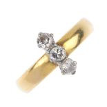 A 22ct gold diamond three-stone dress ring. The brilliant-cut diamond bar, set at right-angles to