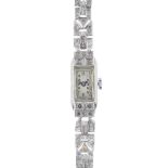 A mid 20th century diamond manual wind cocktail watch. The rectangular-shape white dial and Arabic