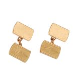 A pair of 1960s 9ct gold cufflinks. Each designed as two rectangular-shape panels, one with engine-