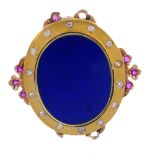 A diamond and gem-set brooch. Designed as an oval-shape lapis lazuli panel, to the old-cut diamond