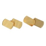 A pair of 1940s 18ct gold cufflinks. Each designed as two rectangular-shape engine turned panels,