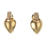 A pair of diamond earrings. Each designed as a textured pear-shape panel, to the pave-set