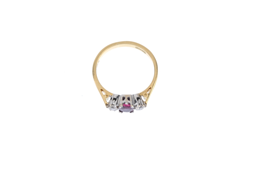 An 18ct gold ruby and diamond three-stone ring. The oval-shape ruby, with brilliant-cut diamond - Image 2 of 4