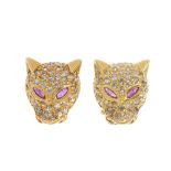 A pair of ruby leopard earrings. Each designed as a pave-set colourless gem leopard face mask,