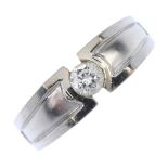 A diamond single-stone ring. The brilliant-cut diamond, to the textured and indented sides, with