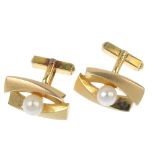 A pair of mid 20th century cultured pearl cufflinks. Each designed as two textured, asymmetric