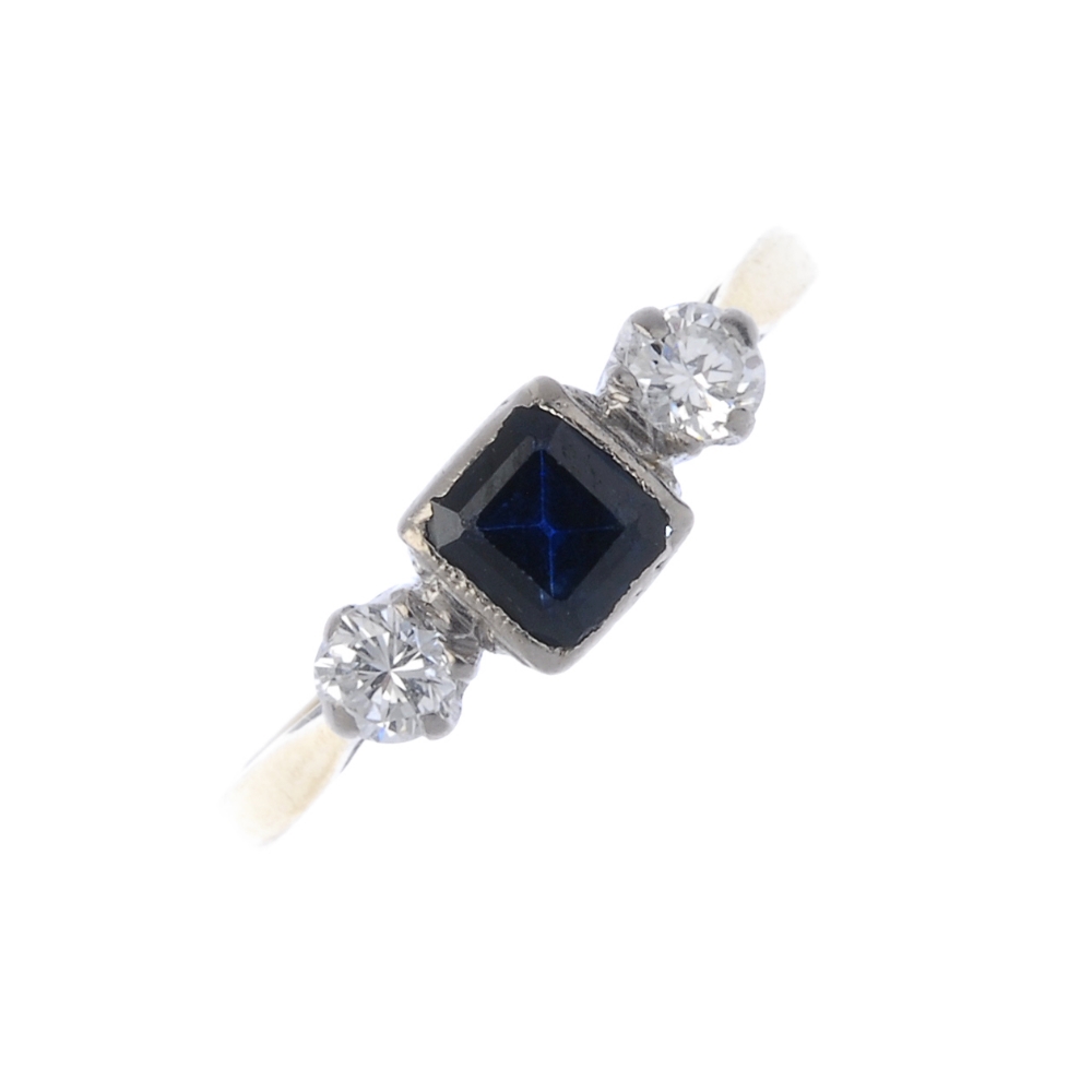 A mid 20th century 18ct gold sapphire and diamond three-stone ring. The square-shape sapphire, to