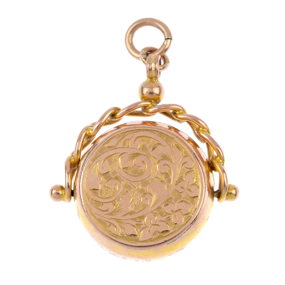An early 20th century 9ct gold swivel fob. The scrolling foliate engraved front and plain reverse,