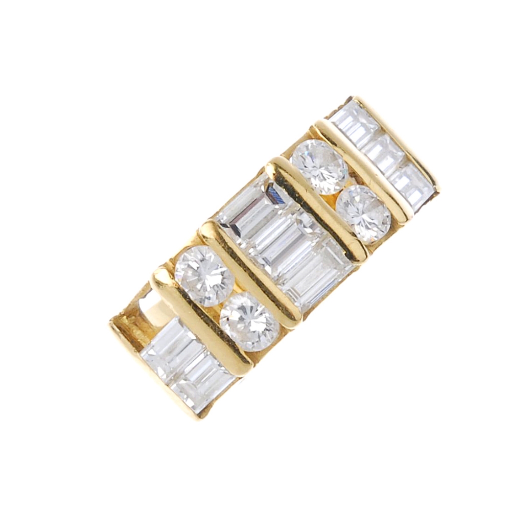 (541429-1-A) A diamond band ring. Comprising alternating brilliant and baguette-cut diamond rows, to