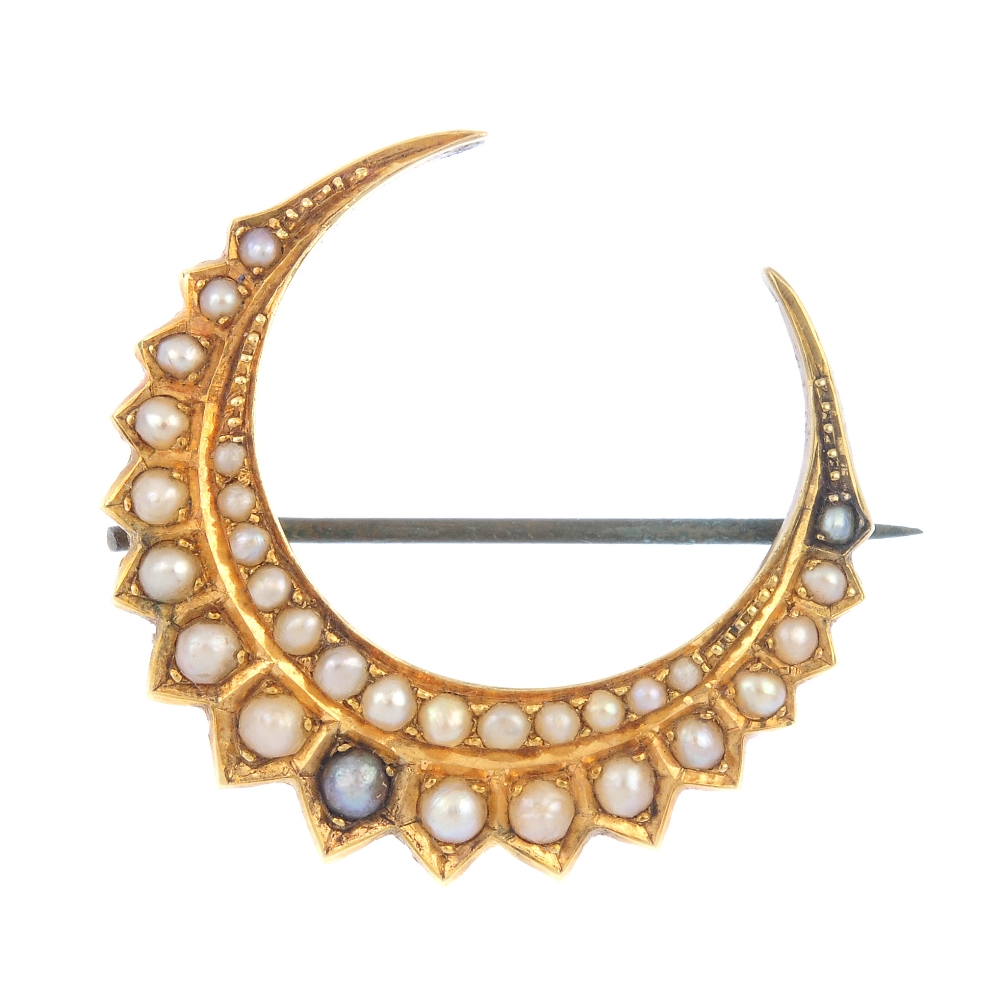 A late 19th century 18ct gold split pearl crescent brooch. Comprising two graduated split pearl
