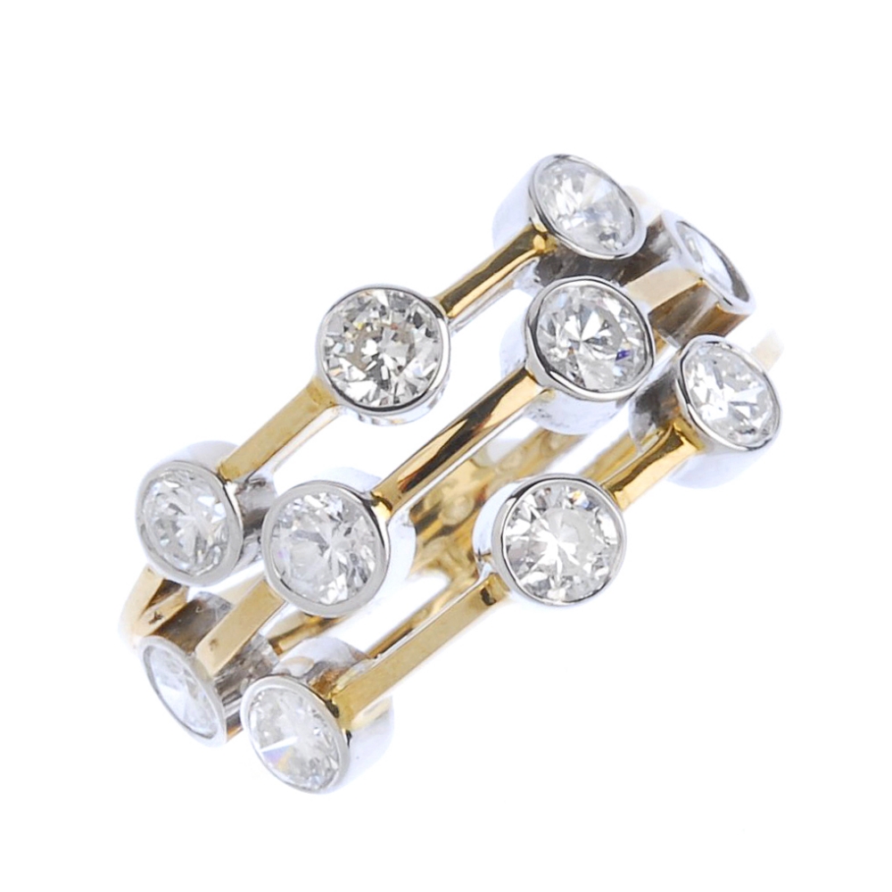 (540912-1-A) A diamond dress ring. Designed as a series of brilliant-cut diamond collets,