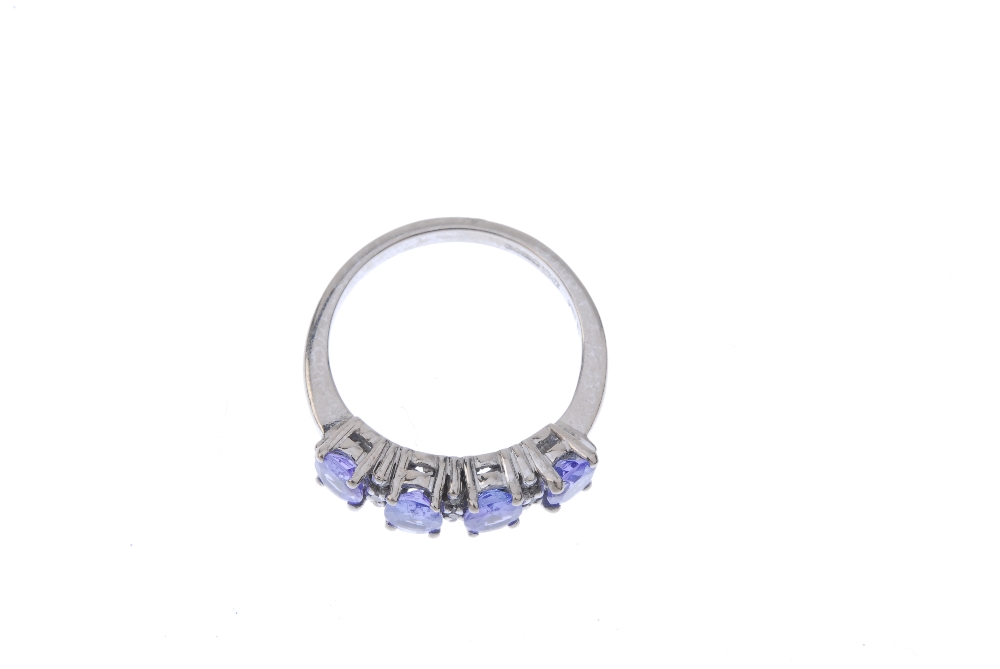 An 18ct gold tanzanite and diamond ring. The oval-shape tanzanite line, interspaced by single-cut - Image 2 of 4