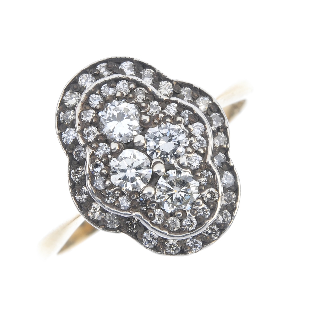 A diamond cluster ring. The brilliant-cut diamond quatrefoil, within a similarly-cut diamond