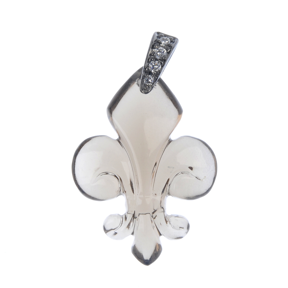 A smokey quartz and diamond pendant. The carved smokey quartz fleur-de-lys, to the brilliant-cut