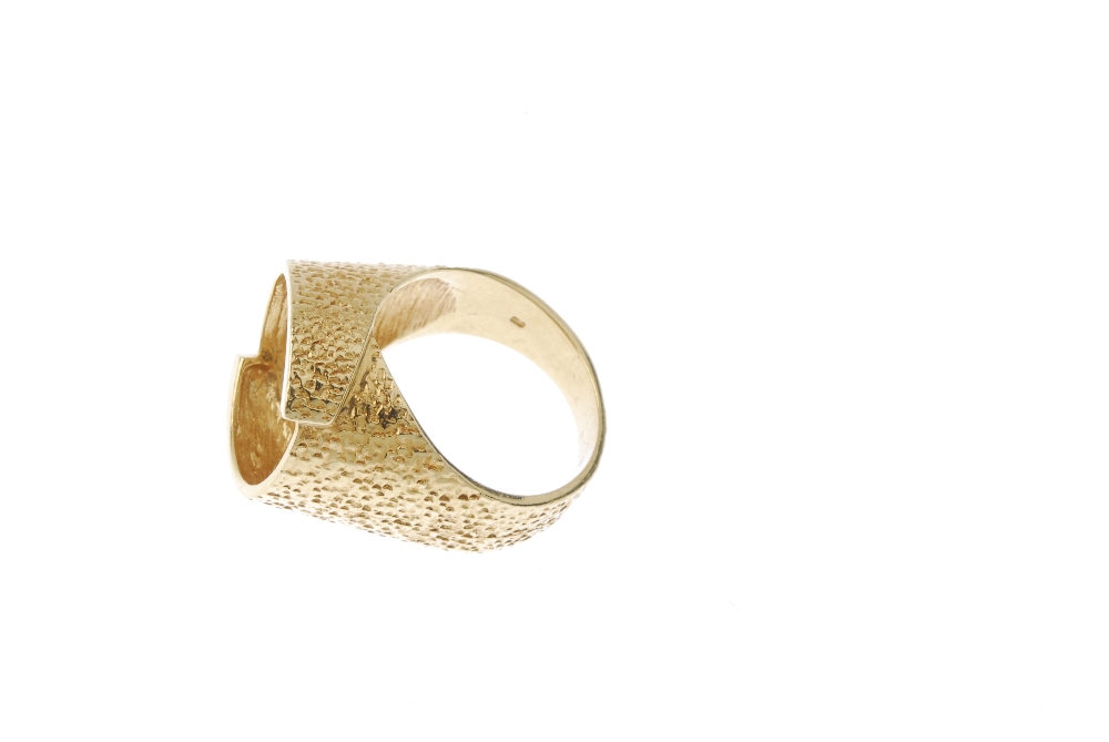 A 1970s 18ct gold textured dress ring. Of textured design, the overlapping panels, forming a central - Image 3 of 4