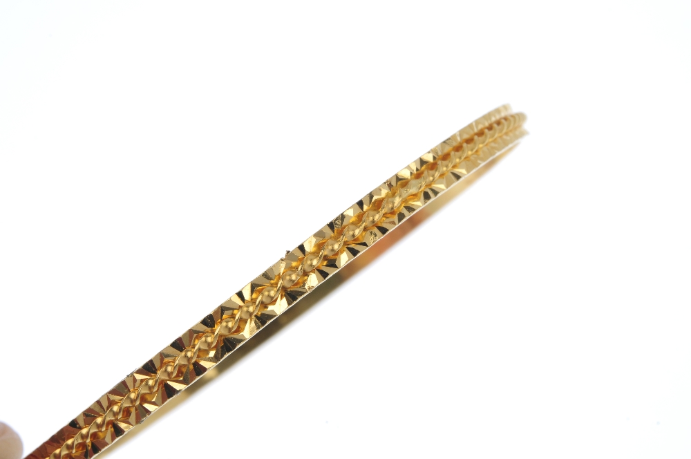 A 22ct gold bangle. Of spiral and bright-cut design. Hallmarks for London, 2007. Inner diameter 6. - Image 2 of 3
