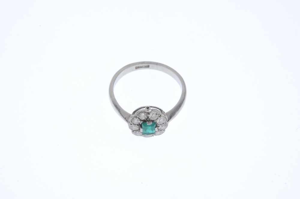 A mid 20th century platinum emerald and diamond cluster ring. The rectangular-shape emerald, - Image 2 of 4