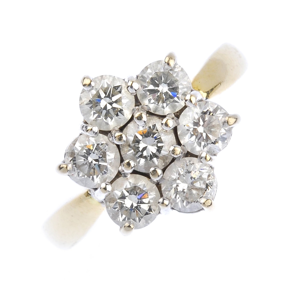 (163989) An 18ct gold diamond cluster ring. Of floral design, the brilliant-cut diamond cluster to