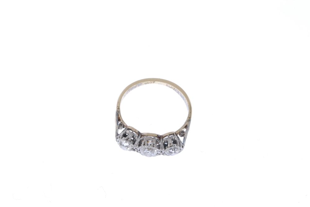 A mid 20th century 18ct gold diamond three-stone ring. The graduated old-cut diamond line, to the - Image 2 of 4