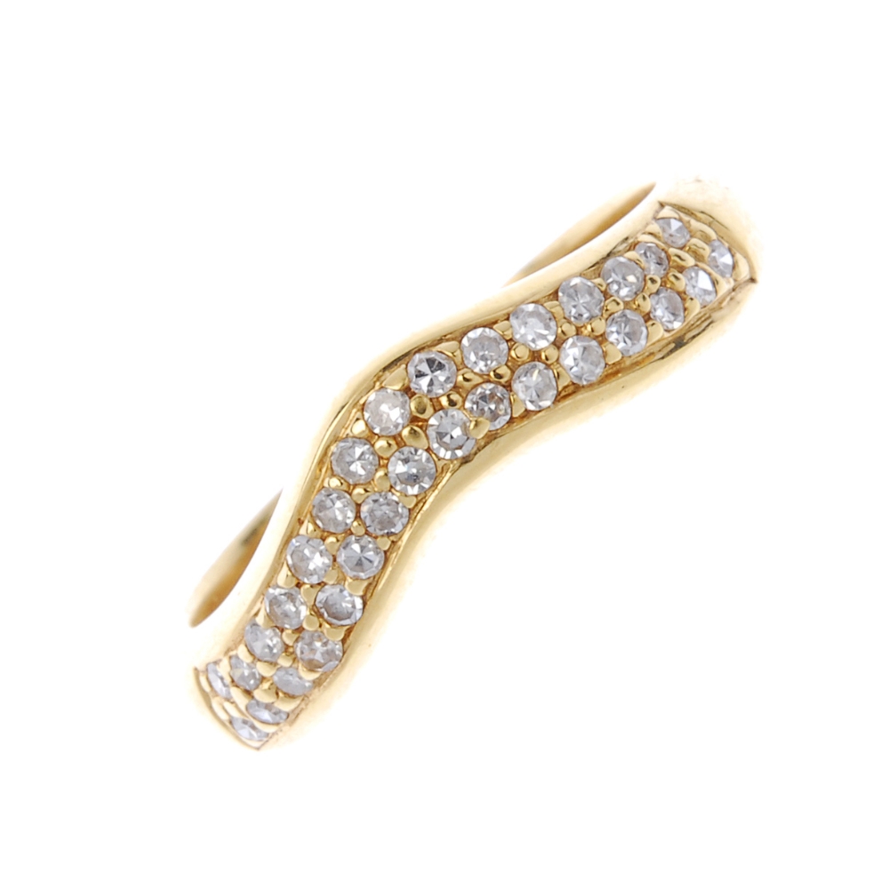 An 18ct gold diamond dress ring. The pave-set diamond chevron, to the plain half-band. Total diamond