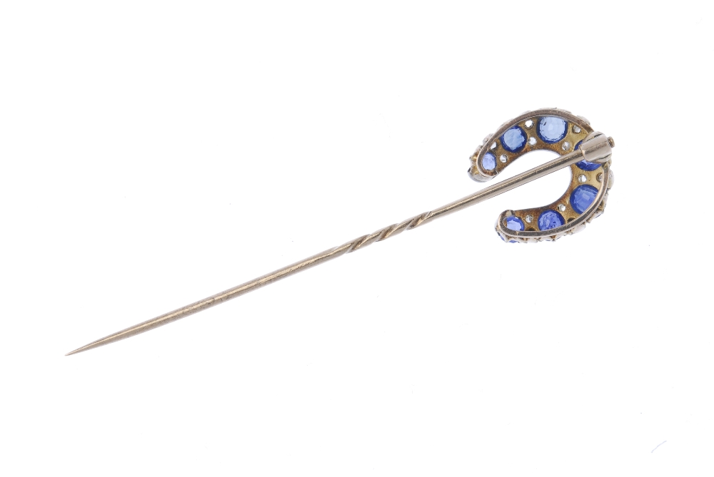 A late 19th century gold sapphire and diamond horseshoe stickpin. The circular-shape sapphire - Image 2 of 2