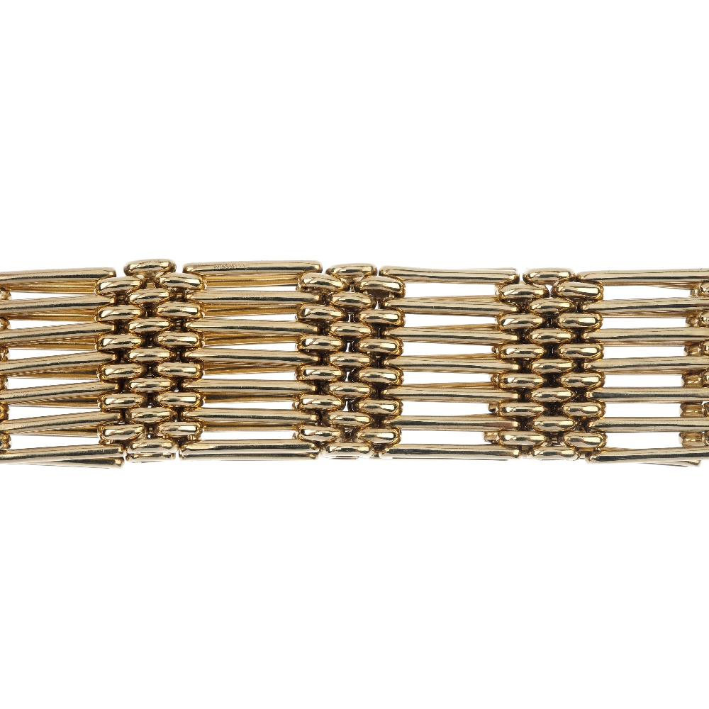 A 9ct gold gate bracelet. Designed as a series of alternating gate and brick links, to the tapered