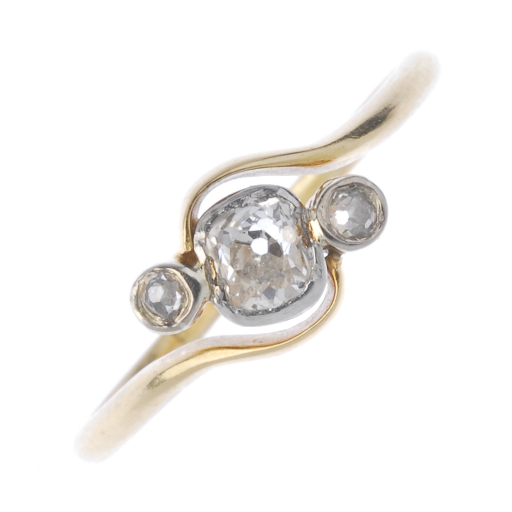 A mid 20th century 18ct gold diamond three-stone ring. The old-cut diamond, with similarly-cut