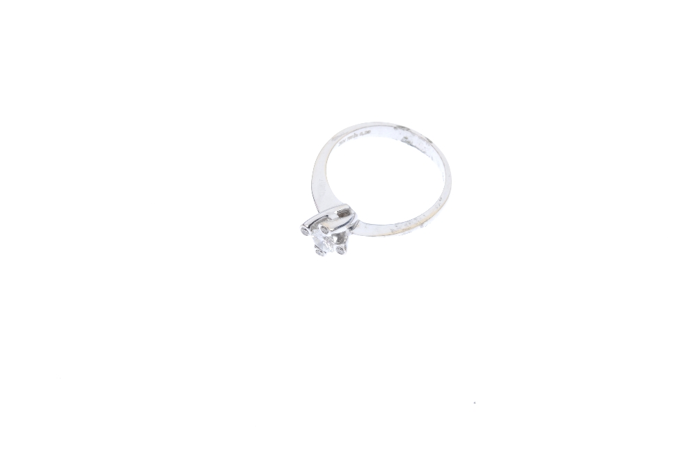 An 18ct gold diamond ring. The brilliant-cut diamond, within a similarly-cut diamond four-claw - Image 2 of 4