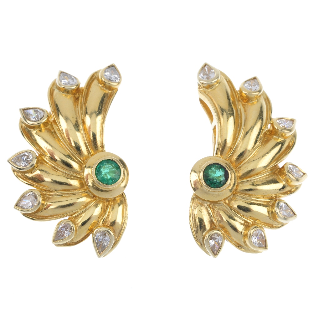 A pair of emerald and diamond earrings. Each designed as a circular-shape emerald collet, with