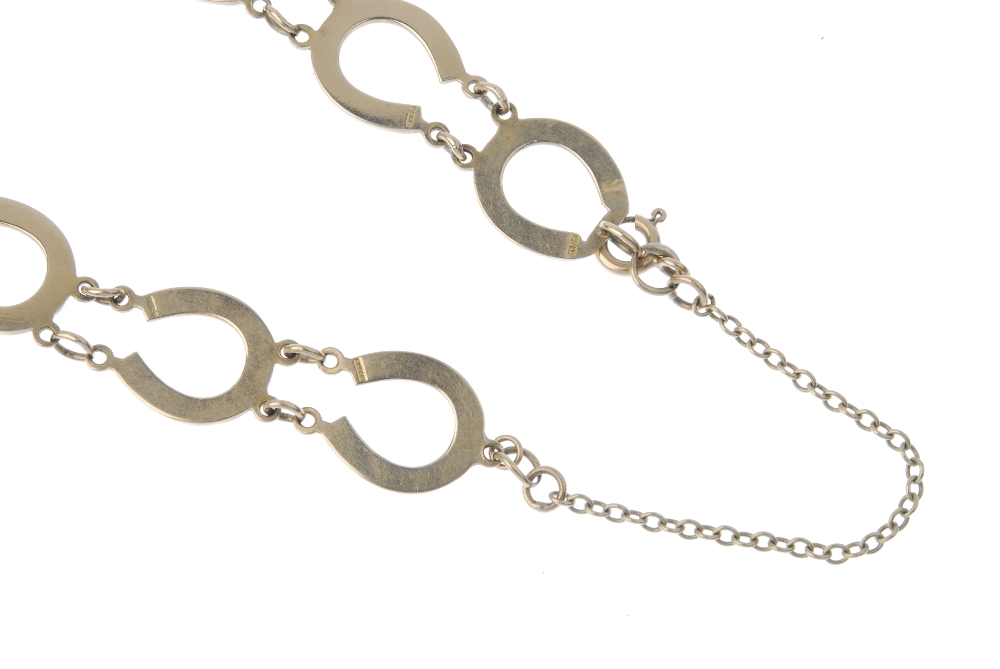 A 9ct gold horseshoe bracelet. Designed as a series of horseshoe links, to the spring ring clasp. - Image 2 of 3