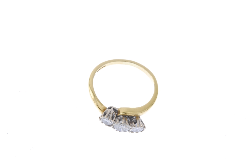 An 18ct gold diamond three-stone ring. The slightly graduated brilliant-cut diamond diagonal line, - Image 2 of 4