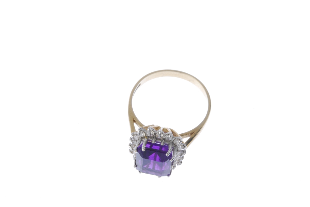 A 9ct gold amethyst and diamond cluster ring. The square-shape amethyst within a brilliant-cut - Image 2 of 4