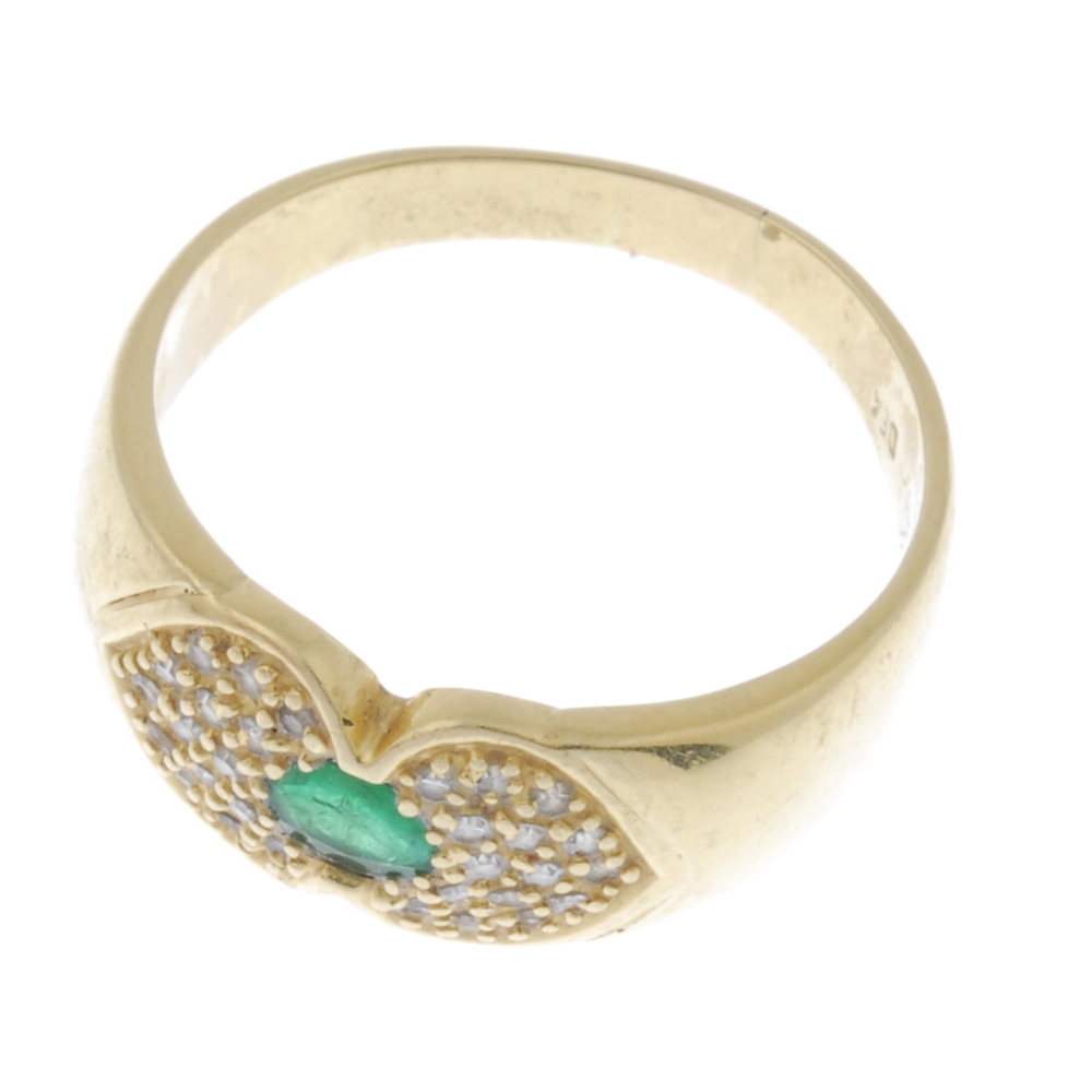 An emerald and diamond ring. The oval-shape emerald, with pave-set diamond sides, to the plain band. - Image 2 of 3