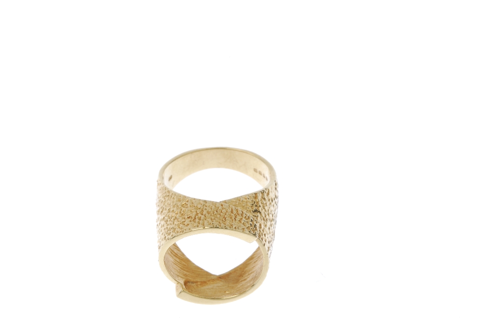 A 1970s 18ct gold textured dress ring. Of textured design, the overlapping panels, forming a central - Image 2 of 4