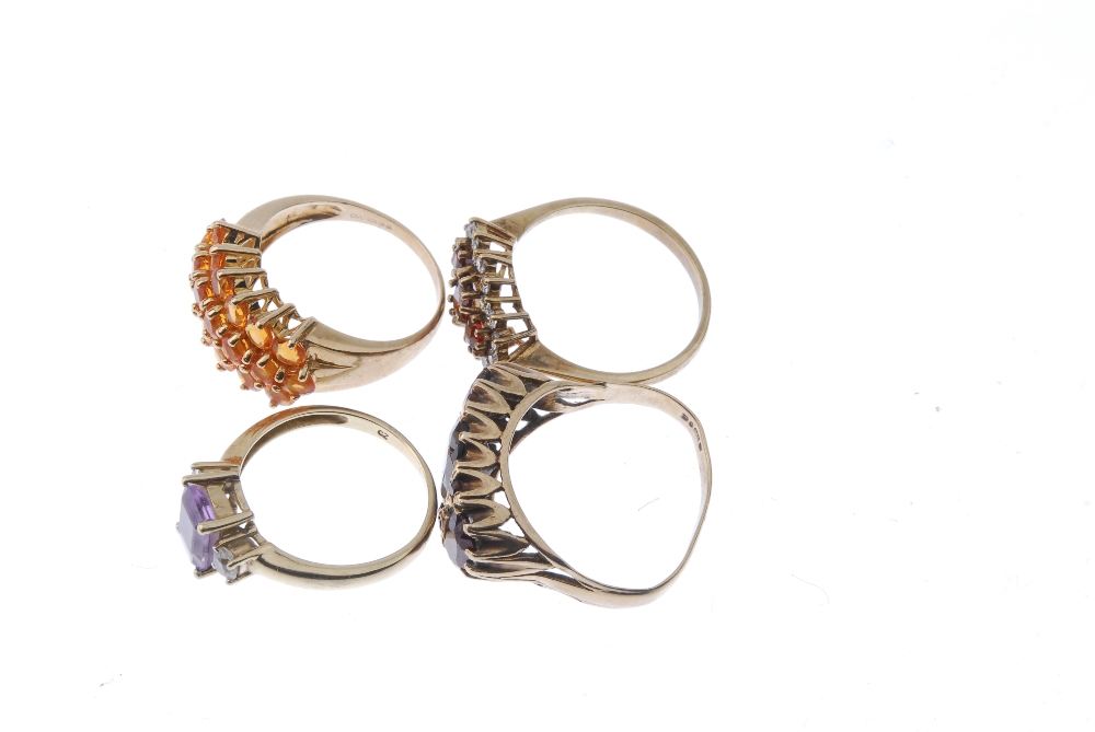 A selection of four 9ct gold gem-set rings. To include a fire opal dress ring, an amethyst and cubic - Image 3 of 4