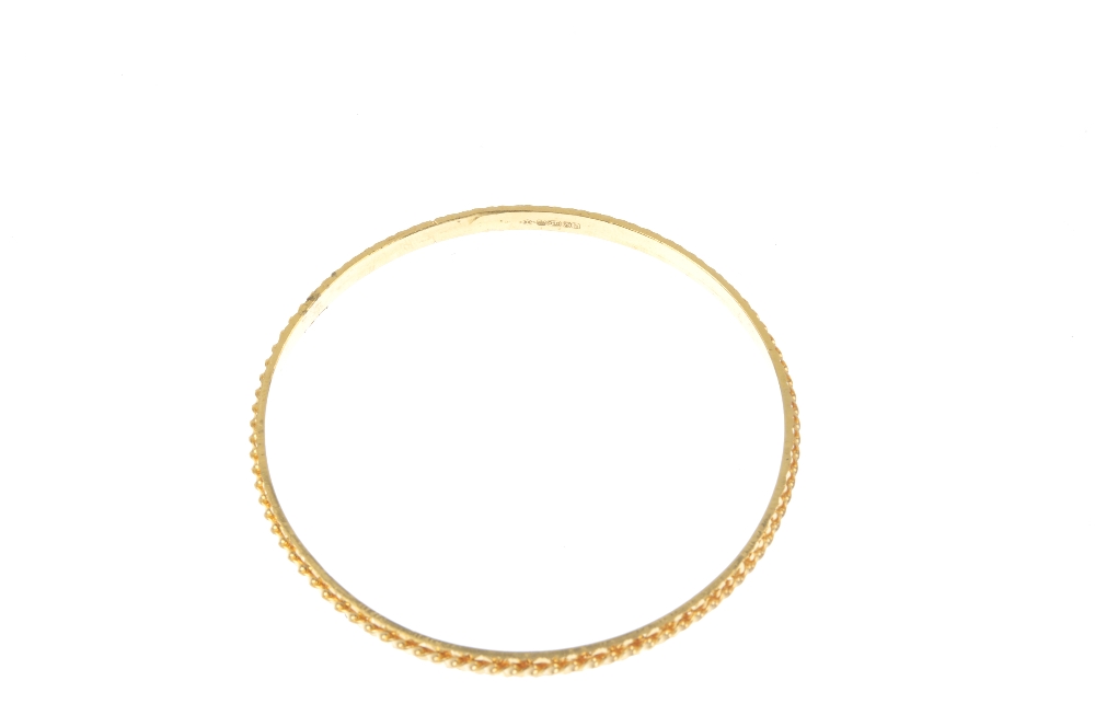 A 22ct gold bangle. Of spiral and bright-cut design. Hallmarks for London, 2007. Inner diameter 6. - Image 3 of 3