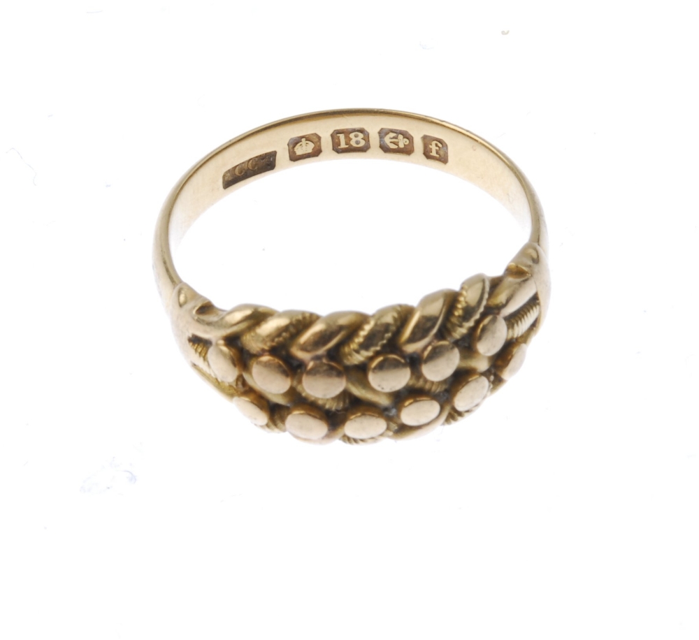 An Edwardian 18ct gold keeper ring. Of interwoven design, with bead accents, to the plain band. - Image 3 of 3