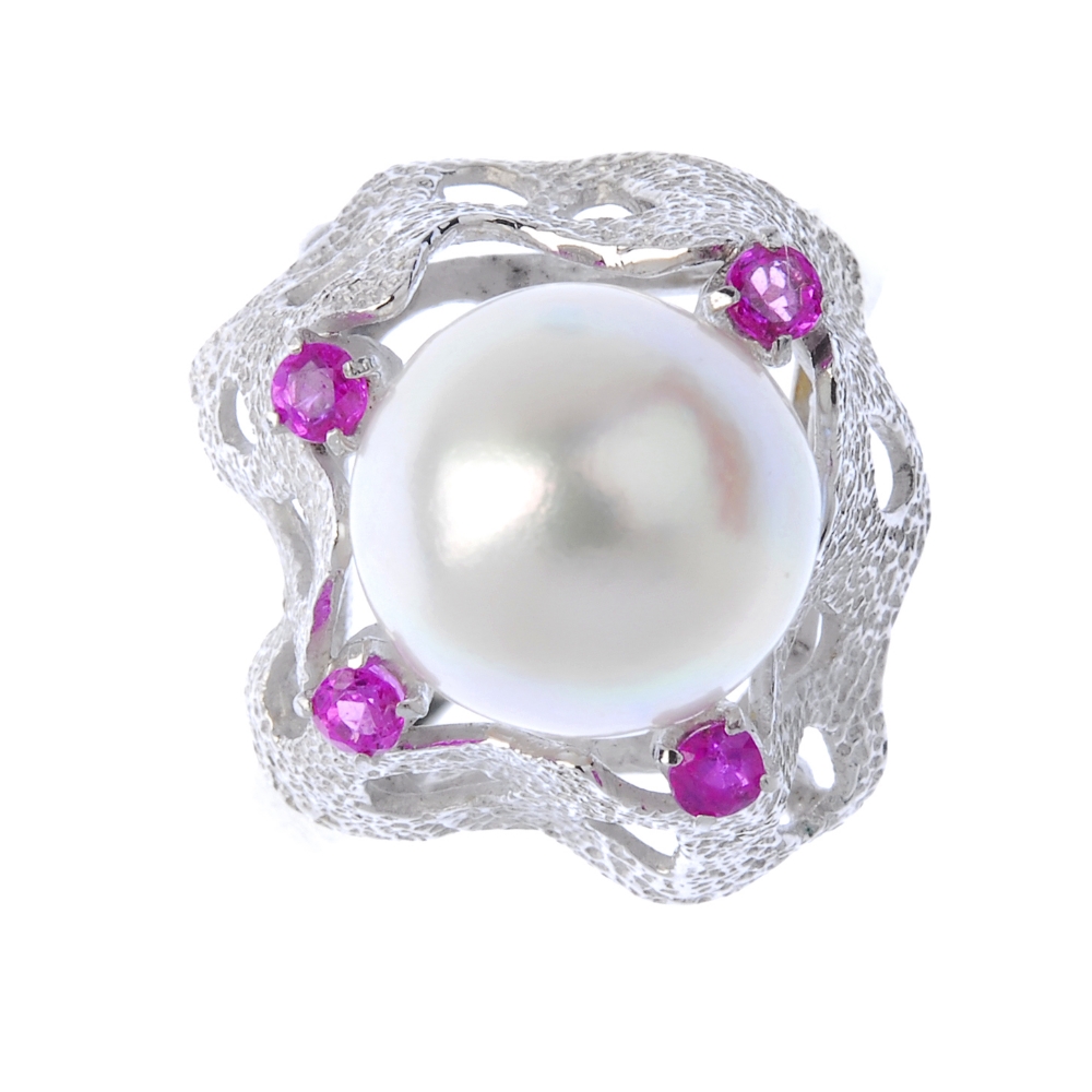 A cultured pearl and sapphire dress ring. he cultured pearl, to the textured undulating surround,