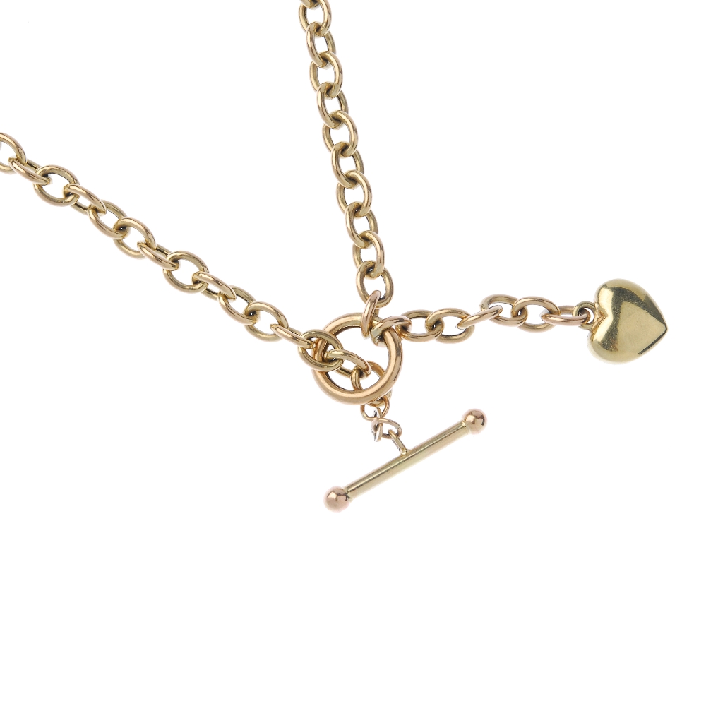 A necklace, with charm. The belcher-link chain, with T-bar and heart-shape charm. Length 50cms.