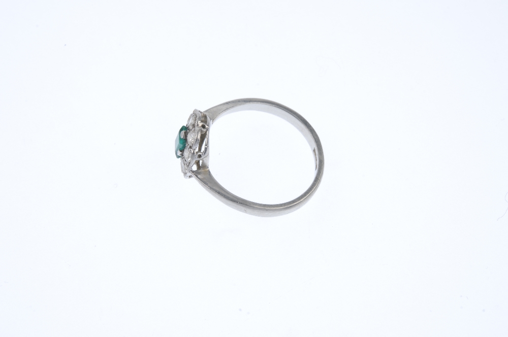 A mid 20th century platinum emerald and diamond cluster ring. The rectangular-shape emerald, - Image 3 of 4