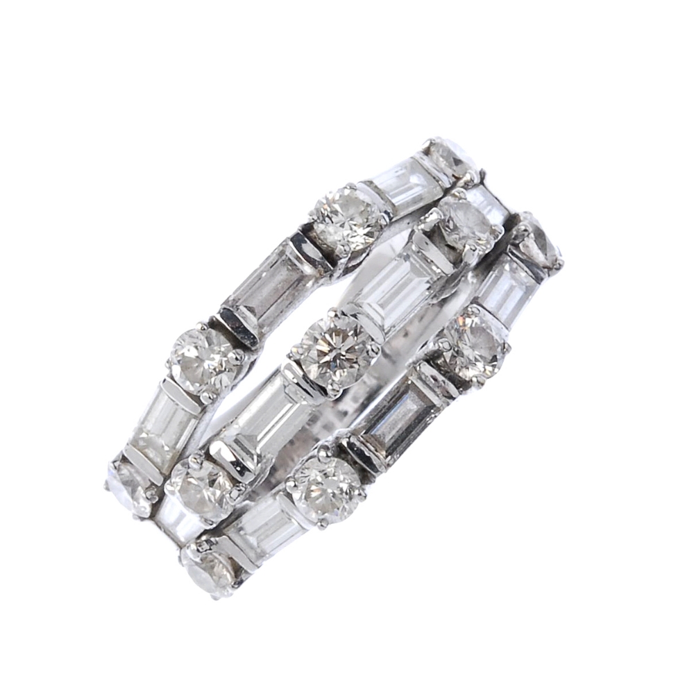 (541429-2-A) A diamond dress ring. Comprising three alternating brilliant and baguette-cut diamond