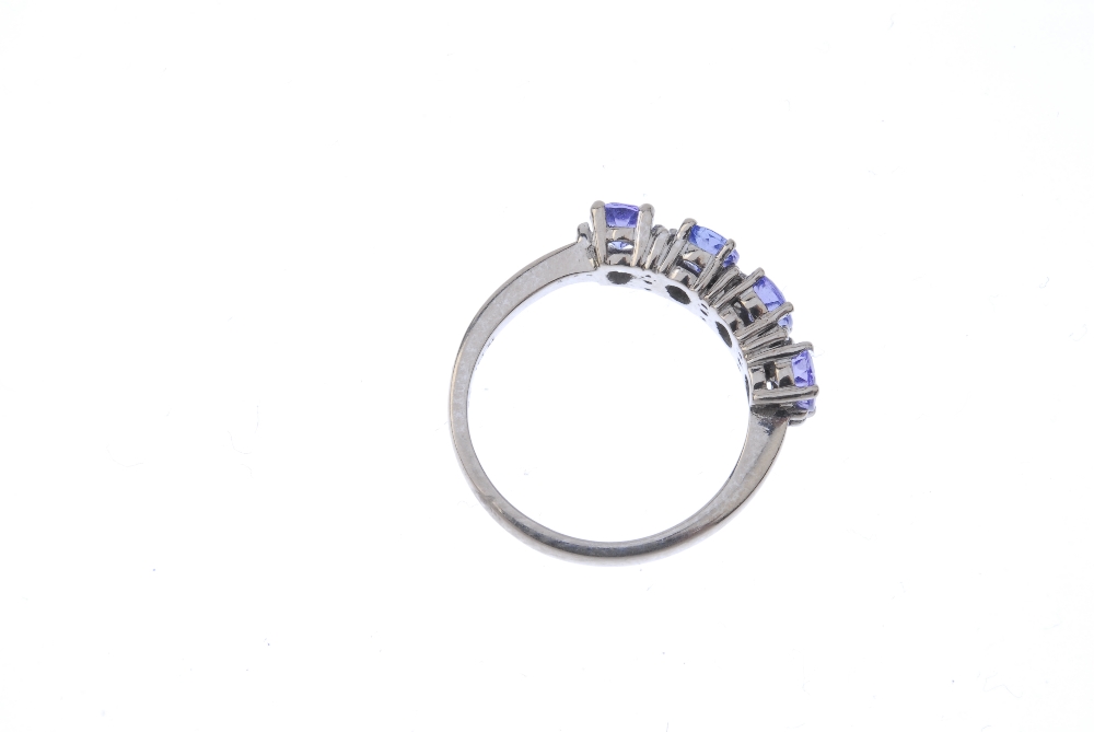 An 18ct gold tanzanite and diamond ring. The oval-shape tanzanite line, interspaced by single-cut - Image 4 of 4