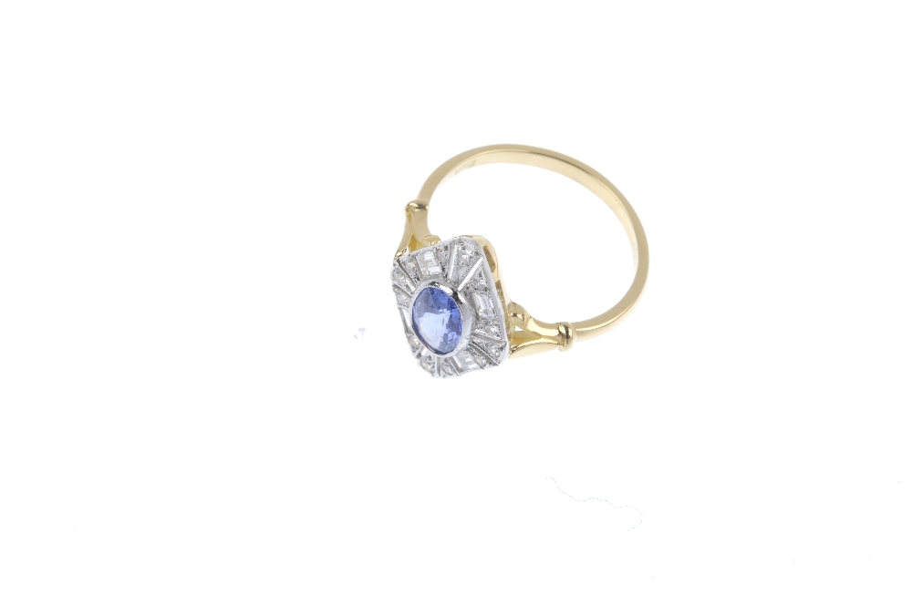 A sapphire and diamond cluster ring. The oval-shape sapphire collet, within an openwork single and - Image 2 of 4