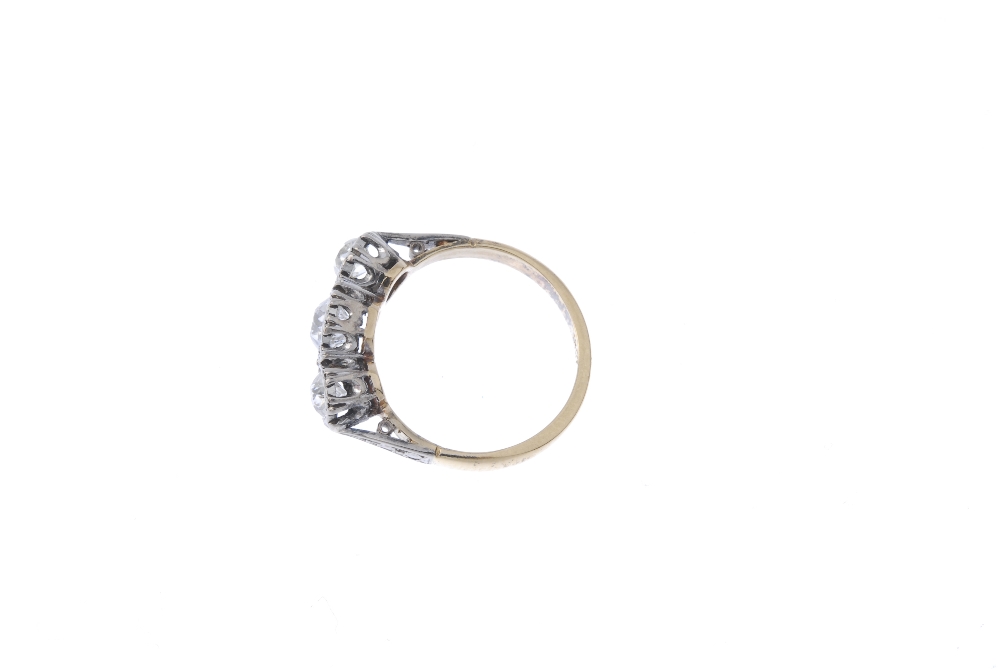 A mid 20th century 18ct gold diamond three-stone ring. The graduated old-cut diamond line, to the - Image 3 of 4